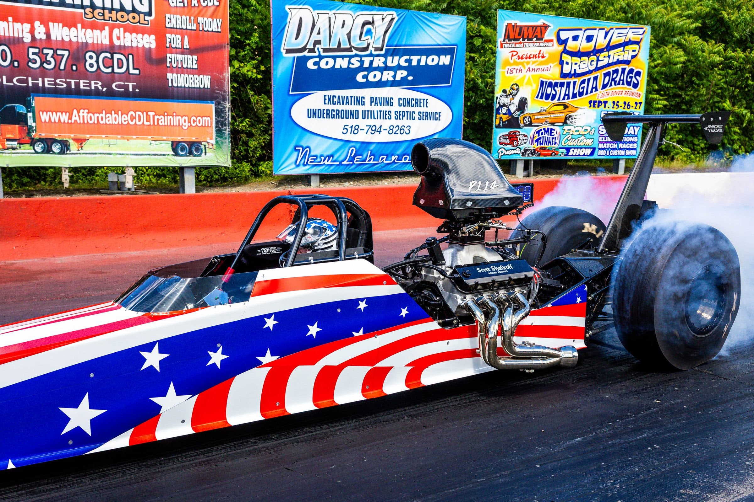 A stars-and-stripes dragster lights up the rear slicks in a pre-run burnout at Lebanon Valley.